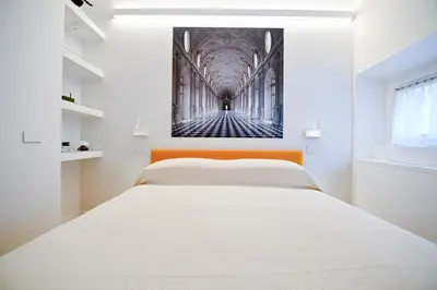 a bedroom with a bed and a painting on the wall at Dolce Vita Suite by Rental in Rome in Rome