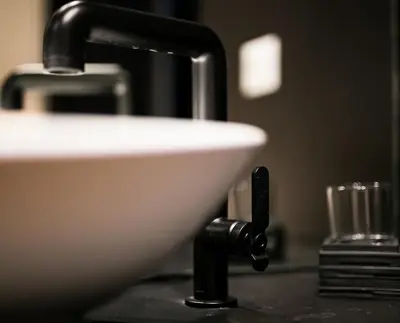 a sink in a bathroom with a black counter at Jb Relais Luxury in Rome