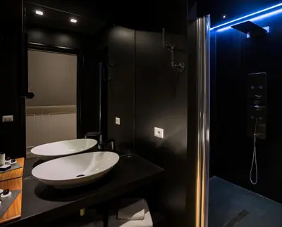 a bathroom with two sinks and a shower at Jb Relais Luxury in Rome