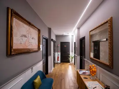 a hallway with a blue couch and a table at Jb Relais Luxury in Rome