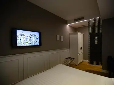 a bedroom with a flat screen tv on the wall at Jb Relais Luxury in Rome