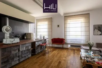 a kitchen with a counter and a table in a room at Casa Lea by Hili in Rome