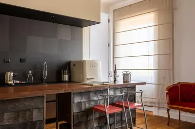 a kitchen with a counter with two stools at Casa Lea by Hili in Rome
