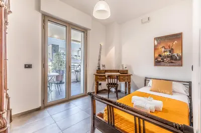 a bedroom with a bed and a table and a desk at L'elegante Casa Di Anna - Roma EUR in Rome