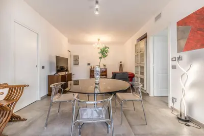 a dining room with a table and chairs at L'elegante Casa Di Anna - Roma EUR in Rome