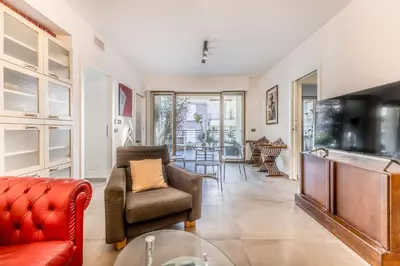 a living room with a couch and a television at L'elegante Casa Di Anna - Roma EUR in Rome