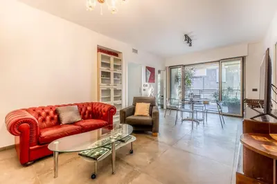 a living room with a red couch and a table at L'elegante Casa Di Anna - Roma EUR in Rome