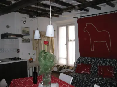 a living room with a table with a horse on the wall at Musa Apartments in Rome