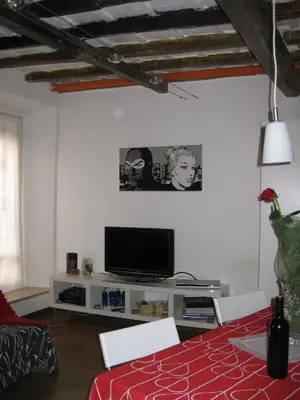 a living room with a television and a table at Musa Apartments in Rome