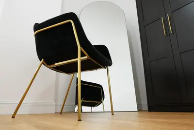 a black and gold chair in a room at Barocci Home in Rome