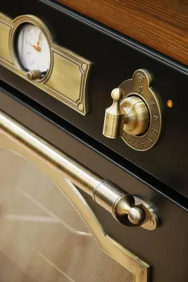 a door with a gold handle and a clock on it at Barocci Home in Rome