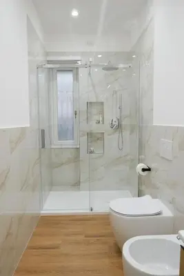 a bathroom with a shower and a toilet and a sink at Barocci Home in Rome