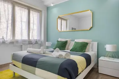 a bedroom with a large bed with a mirror at Conca D'Oro Guest House - Elisabetta in Rome
