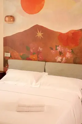 a bedroom with a bed with a painting on the wall at Independent house- Heart of Rome in Rome