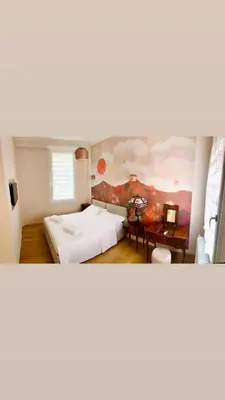 a room with a bed and a painting on the wall at Independent house- Heart of Rome in Rome