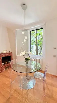 a dining room with a glass table and chairs at Independent house- Heart of Rome in Rome