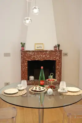 a glass table with food on it in a room with a fireplace at Independent house- Heart of Rome in Rome