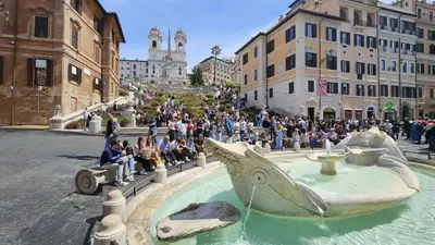 a crowd of people sitting around a fountain in a city at Independent house- Heart of Rome in Rome