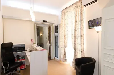 a living room with a chair and a desk and a window at Gemme Di Roma Accomodation in Rome