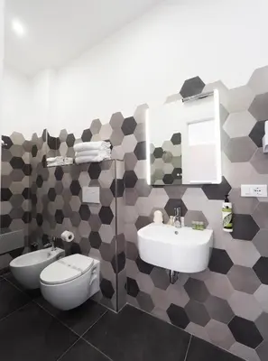 a bathroom with a sink and a toilet and a mirror at Casa Di David in Rome