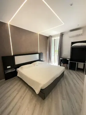 a bedroom with a large bed and a tv at Isabel Rooms in Rome