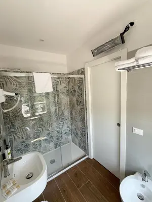 a bathroom with a shower and a sink and a toilet at Isabel Rooms in Rome