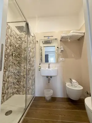 a bathroom with a sink and a shower at Isabel Rooms in Rome