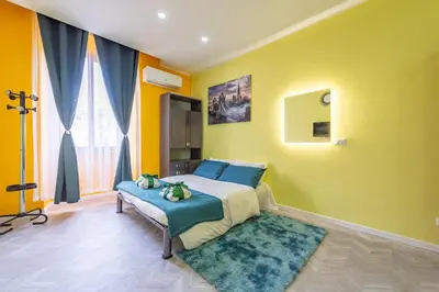 a bedroom with a bed and a yellow wall at Eternal Residency Roman Escape in Rome