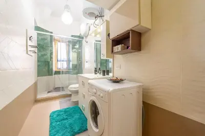 a laundry room with a washing machine in a bathroom at Eternal Residency Roman Escape in Rome