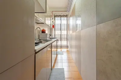a kitchen with white walls and a long hallway at Eternal Residency Roman Escape in Rome