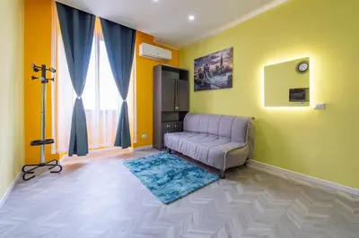a living room with a couch and a window at Eternal Residency Roman Escape in Rome