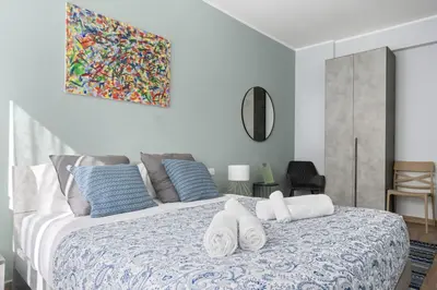 a bedroom with a large bed with towels on it at Conca D'Oro Guest House - Anna in Rome