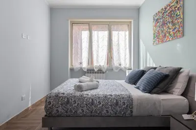 a bedroom with a bed with a teddy bear on it at Conca D'Oro Guest House - Anna in Rome