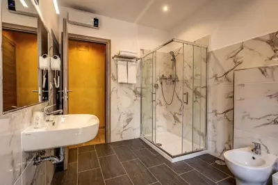 a bathroom with two sinks and a shower at Osimar Rooms in Rome