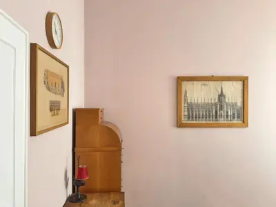 a living room with a blue couch and a lamp at Monti - Colosseum - Boschetto Vintage - 2BR in Rome