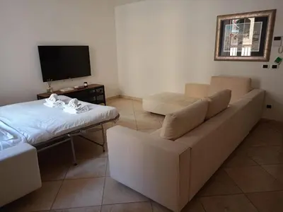 a living room with a couch and a bed at Charming Apartment in Trastevere in Rome