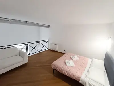 a white room with a bed and a couch at Charming Apartment in Trastevere in Rome
