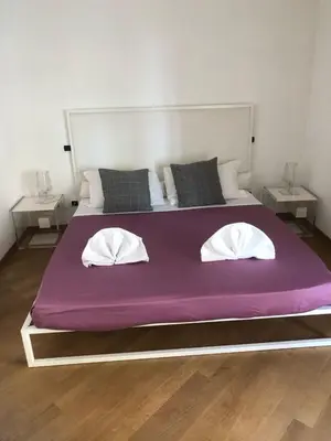 a large purple bed with two pillows on it at Charming Apartment in Trastevere in Rome