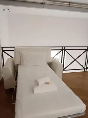 a white bed with a ring on top of it at Charming Apartment in Trastevere in Rome