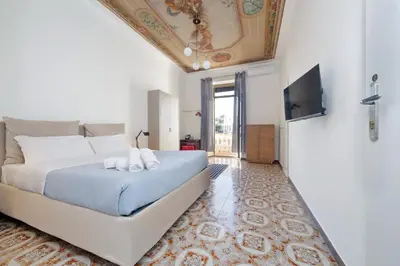 a bedroom with a large bed with a ceiling at Trastevere 70 in Rome