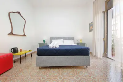 a bedroom with a bed and a mirror on the wall at Trastevere 70 in Rome