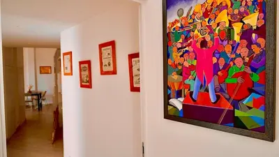 a painting hanging on a wall in a hallway at Entire Flat at Last floor in Piazza Bologna in Rome