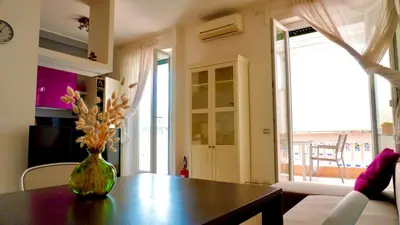 a vase of flowers on a table in a living room at Entire Flat at Last floor in Piazza Bologna in Rome