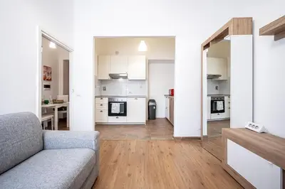 a living room with a couch and a kitchen at Feel at Home I Modern Cozy Apartment in Rome