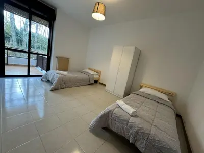 a bedroom with two beds and a large window at RAHIMA GUEST HOUSe 2 in Rome