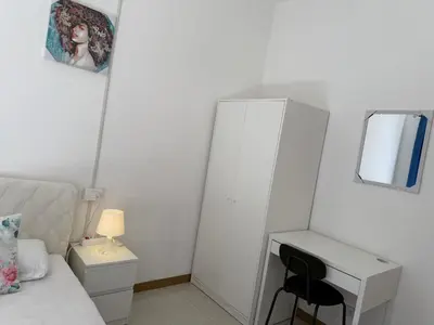 a bedroom with a bed and a desk and a mirror at RAHIMA GUEST HOUSe 2 in Rome
