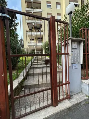 an iron fence with a gate in front of a building at RAHIMA GUEST HOUSe 2 in Rome