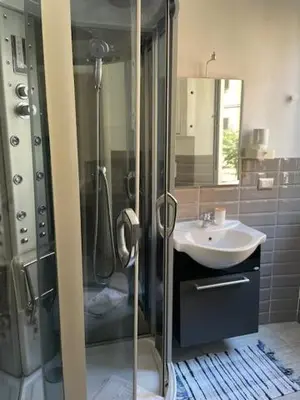 a bathroom with a shower and a sink at the room in the museum in Rome