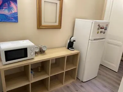 a kitchen with a microwave and a refrigerator at the room in the museum in Rome