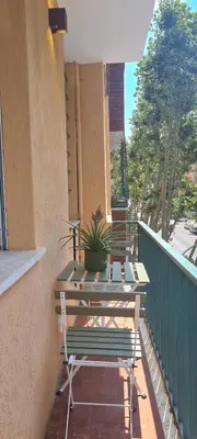 a balcony with two benches and a table on a building at Maison Viola in Rome